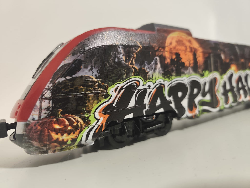 Close-up of the Happy Halloween graffiti lettering with pumpkins, ghosts and moonlit scenery