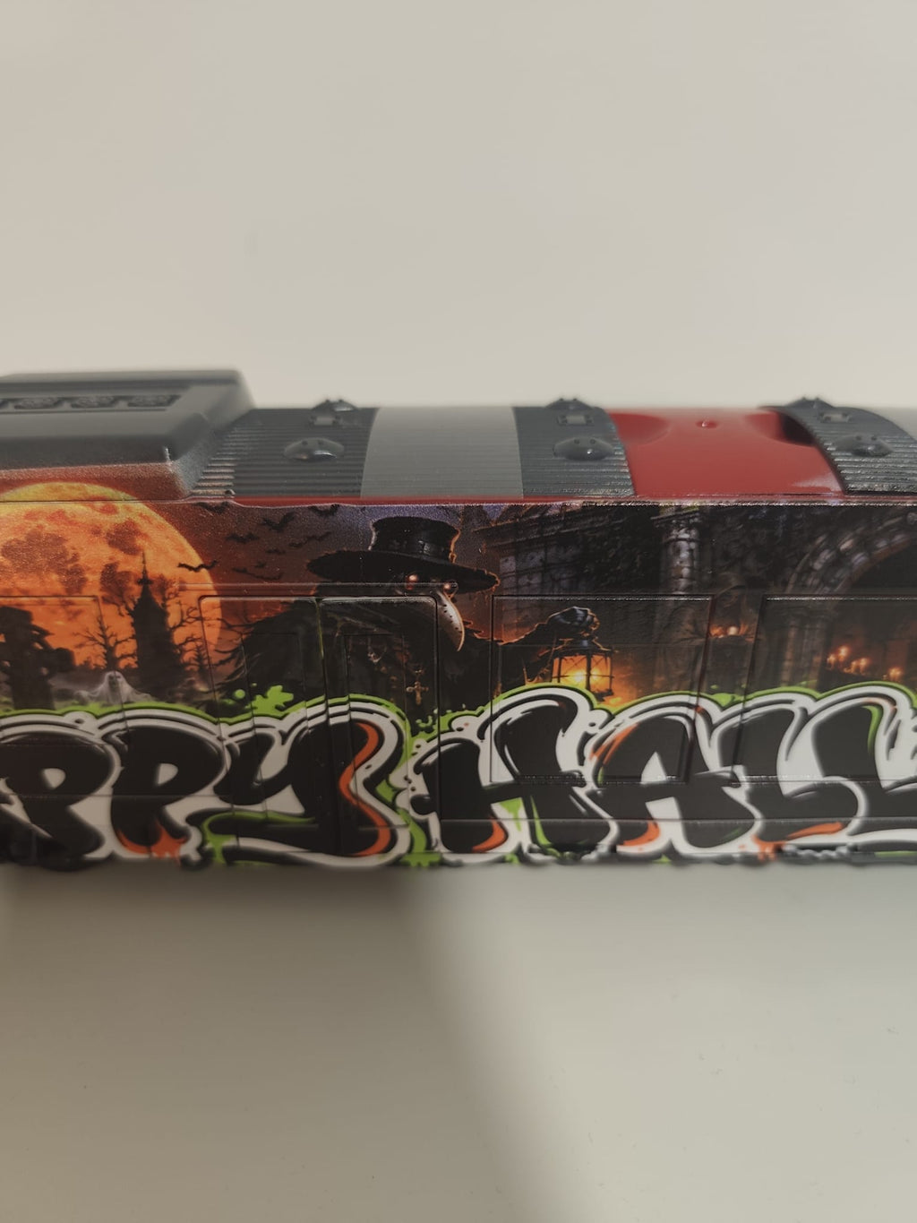 Full side view of the 40 × 10 cm Happy Halloween graffiti train with direct UV-printed artwork