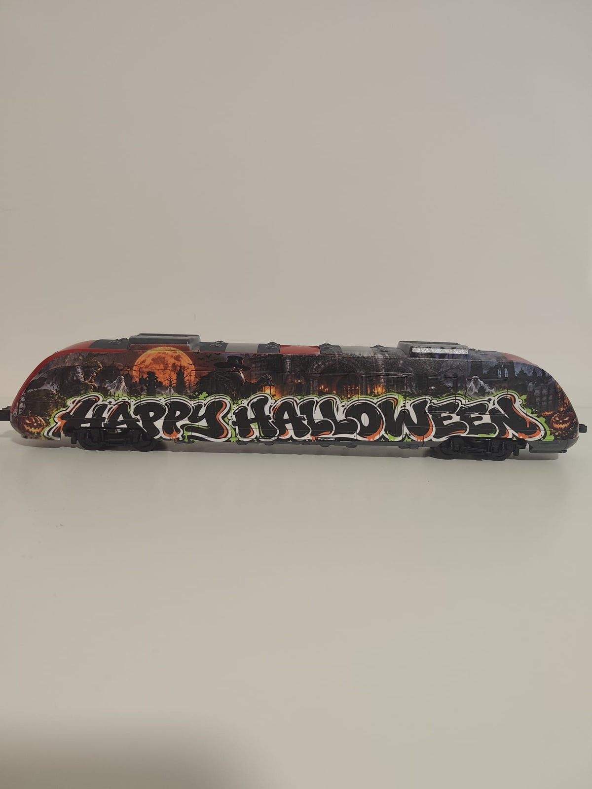 Rear section of the UV-printed Halloween train art object with orange, green, black and white details